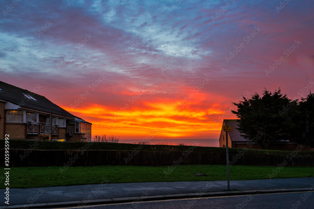 Looking East a Rising Winter Sun casts it's golden rays on the Clouds over Bridlington's North Bay reflecting into the North Sea and Buildings Alike Looking East a Rising Winter Sun casts it's golden rays on the Clouds over Bridlington's North Bay reflecting into the North Sea and Buildings Alike