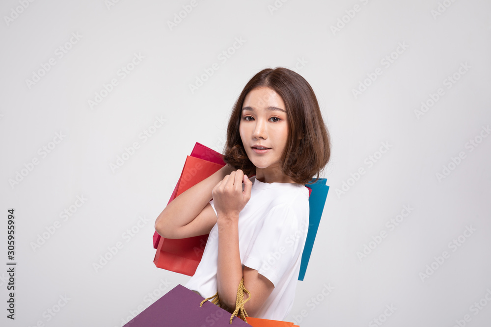 Shopping Asian woman with short hairs smile and Holding Shopping bags, Cheerful and happiness emotional, Enjoy Shopping in black friday sale, Isolated on gray background, Shopping Concept Shopping Asian woman with short hairs smile and Holding Shopping bags, Cheerful and happiness emotional, Enjoy Shopping in black friday sale, Isolated on gray background, Shopping Concept