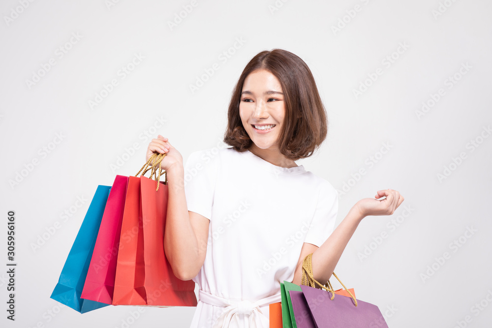 Shopping Asian woman with short hairs smile and Holding Shopping bags, Cheerful and happiness emotional, Enjoy Shopping in black friday sale, Isolated on gray background, Shopping Concept Shopping Asian woman with short hairs smile and Holding Shopping bags, Cheerful and happiness emotional, Enjoy Shopping in black friday sale, Isolated on gray background, Shopping Concept
