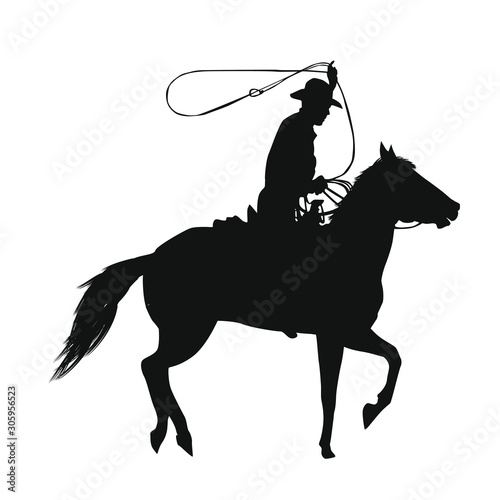 Silhouette of a cowboy riding a horse while using a lasso