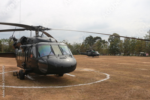 rotary wing aircraft, pilots, stood, park, center field. photo