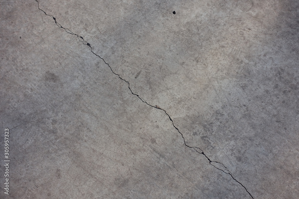 Obraz premium Light grey concrete slab with diagonal crack from above
