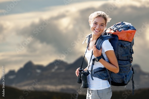 Woman with backpack trekking through the wilderness