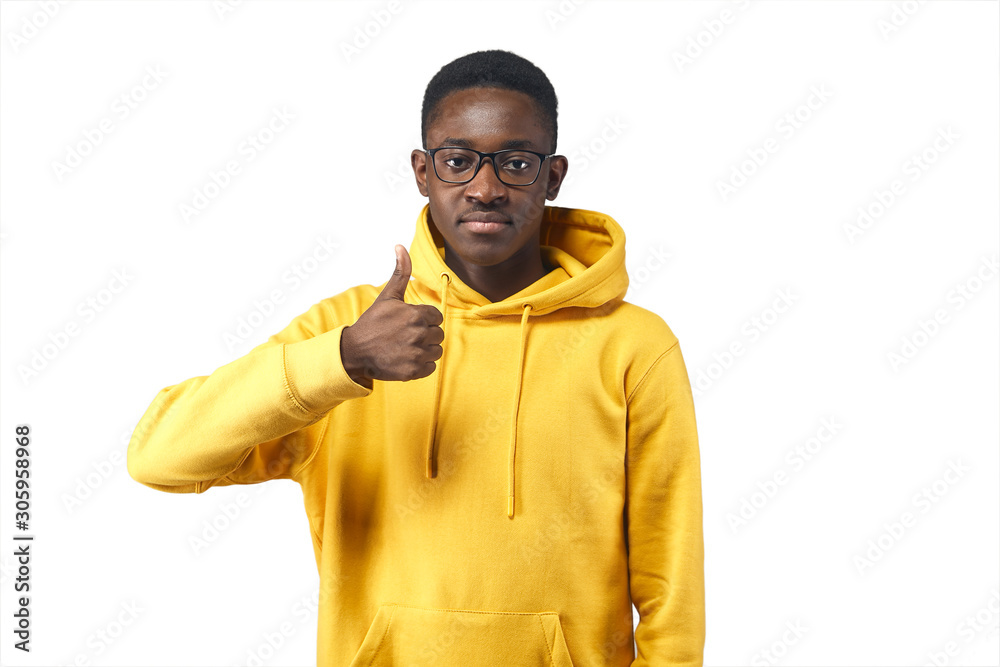 young black man in yellow hoodie in glasses shows likes