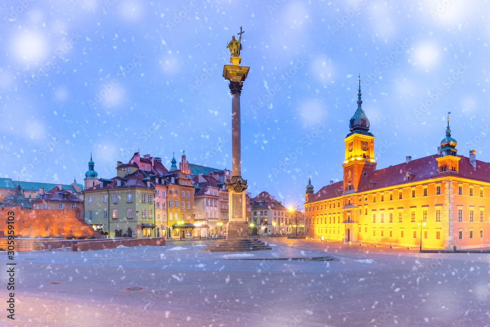 Castle Square with Royal Castle, colorful houses and Sigismund Column in Old town during snowy morning blue hour, Warsaw, Poland.