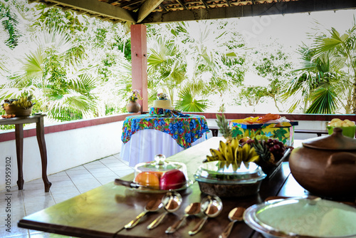 breakfast table on the porch, breakfast on the farm, table with northeastern decor, breakfast table with clay pot, crock pot, farm hotel, country house, farm breakfast,  breakfast table photo