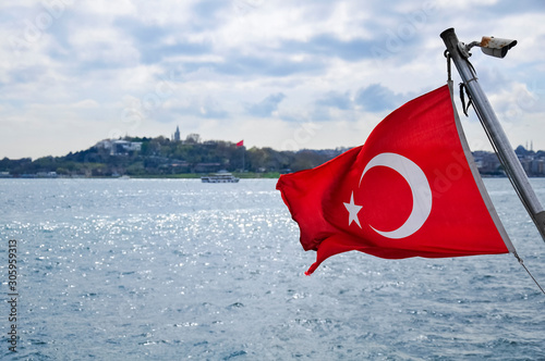 Turkish flag close-up developing on a background of sea view from a boat. Symbol of istanbul. TURKEY