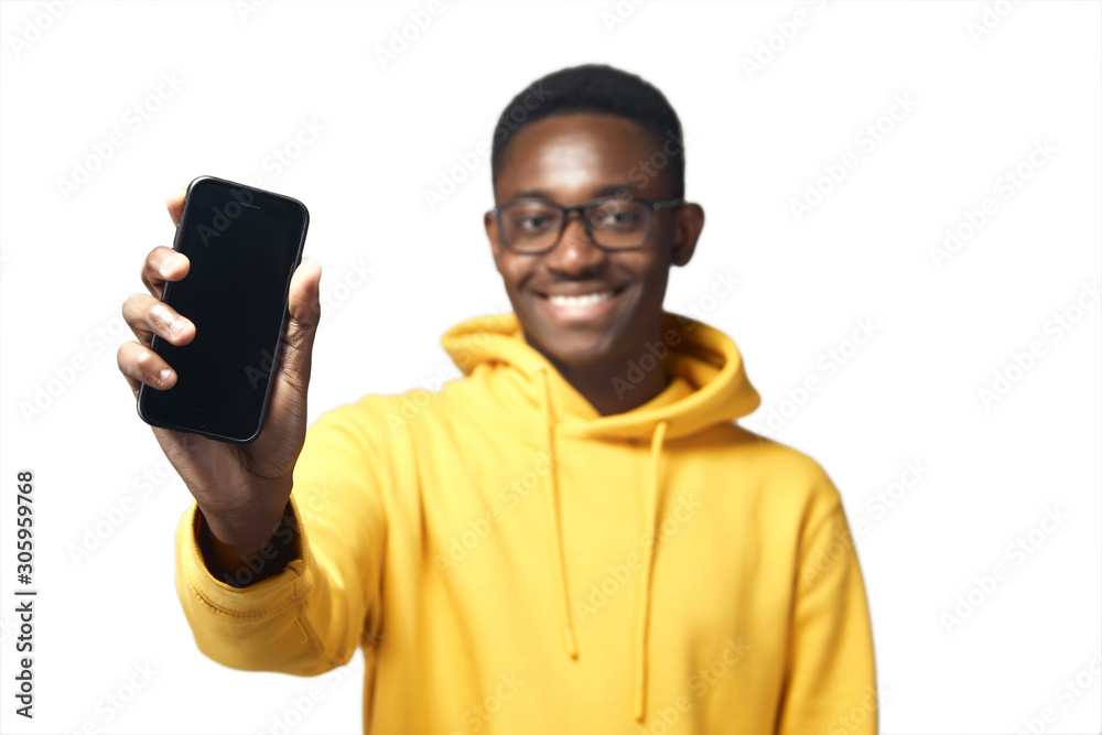 young black man in yellow hoodie with phone young black man in yellow hoodie with phone