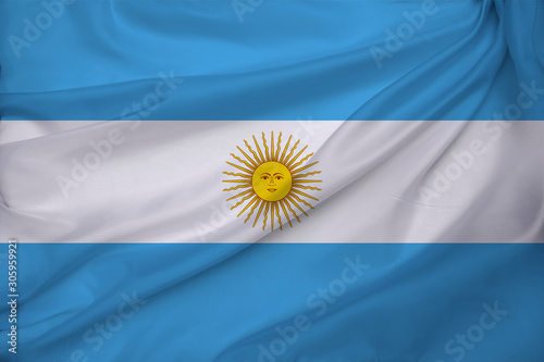 photo of the national flag of Argentina on a luxurious texture of satin, silk with waves, folds and highlights, close-up, copy space, travel concept, economy and state policy