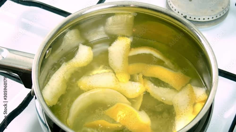 Boiling lemon peels in saucepan Boiling lemon peels in saucepan