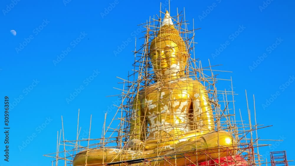 Golden Buddha statue under reconstruction with Blue Sky and White Cloud ...