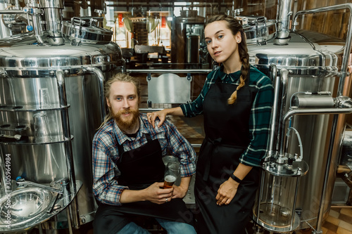 Portrait of Brewery workers. Male and female brewer at brewery factory. 4k. Small business concept.