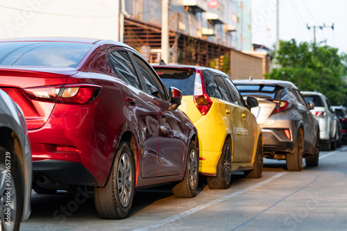 Red and yellow cars parking in line.