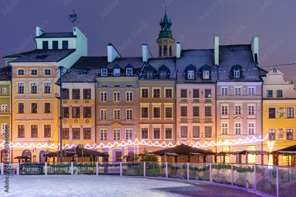 Old Town Market Place with colorful houses during morning blue hour, Warsaw, Poland.