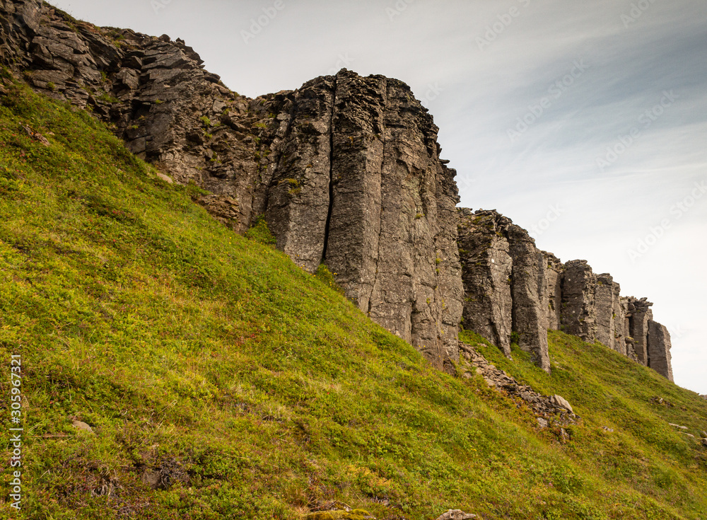 Basalt columns forming a huge wall, volcanic rock sculpture