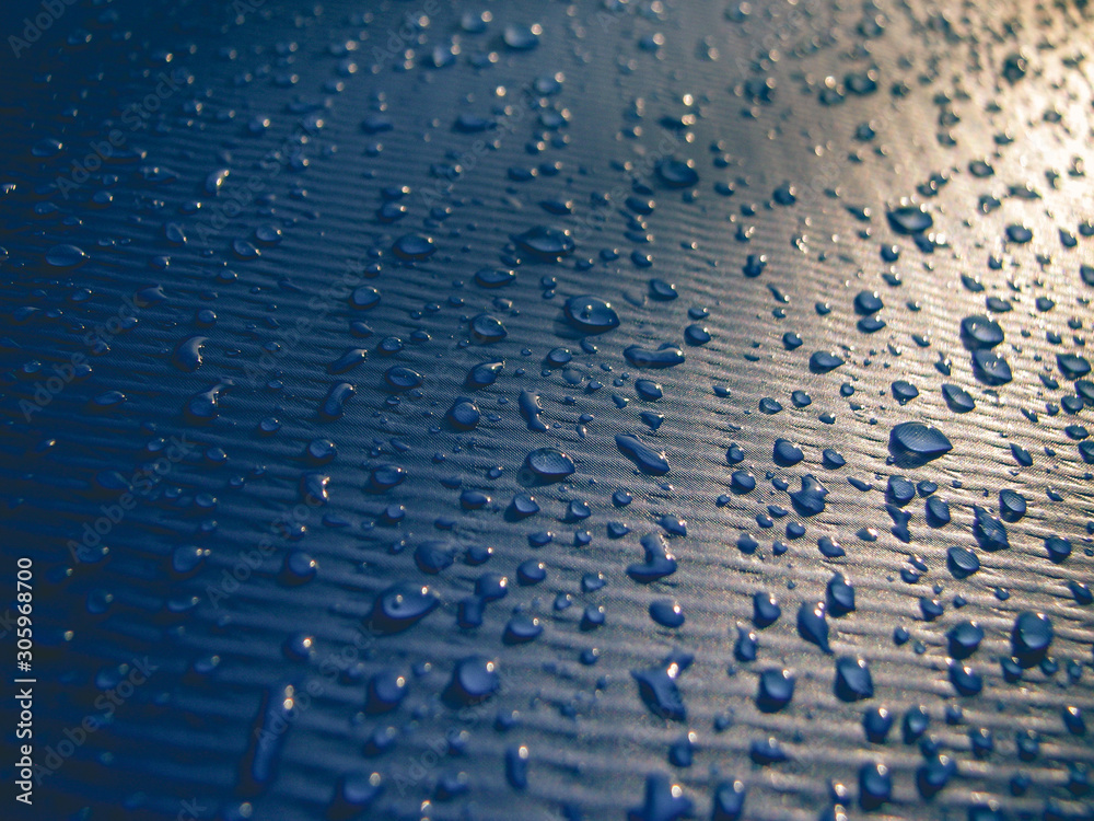 Obraz premium Water drops on a blue swimming pool's exterior. Sunlight, textured, background, shadow.