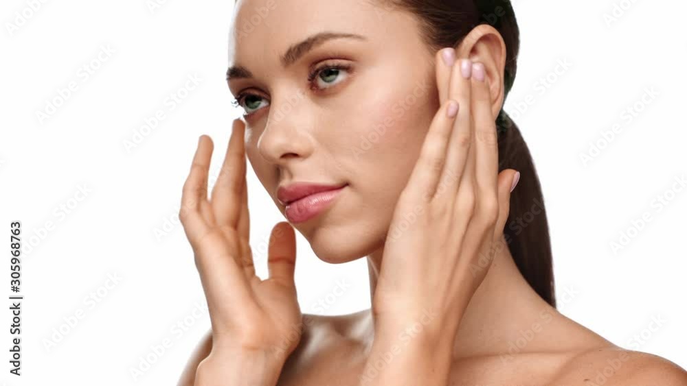 woman touching face and smiling at camera isolated on white woman touching face and smiling at camera isolated on white