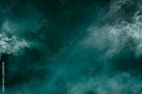 spectacular abstract white smoke isolated in color green background © mitev