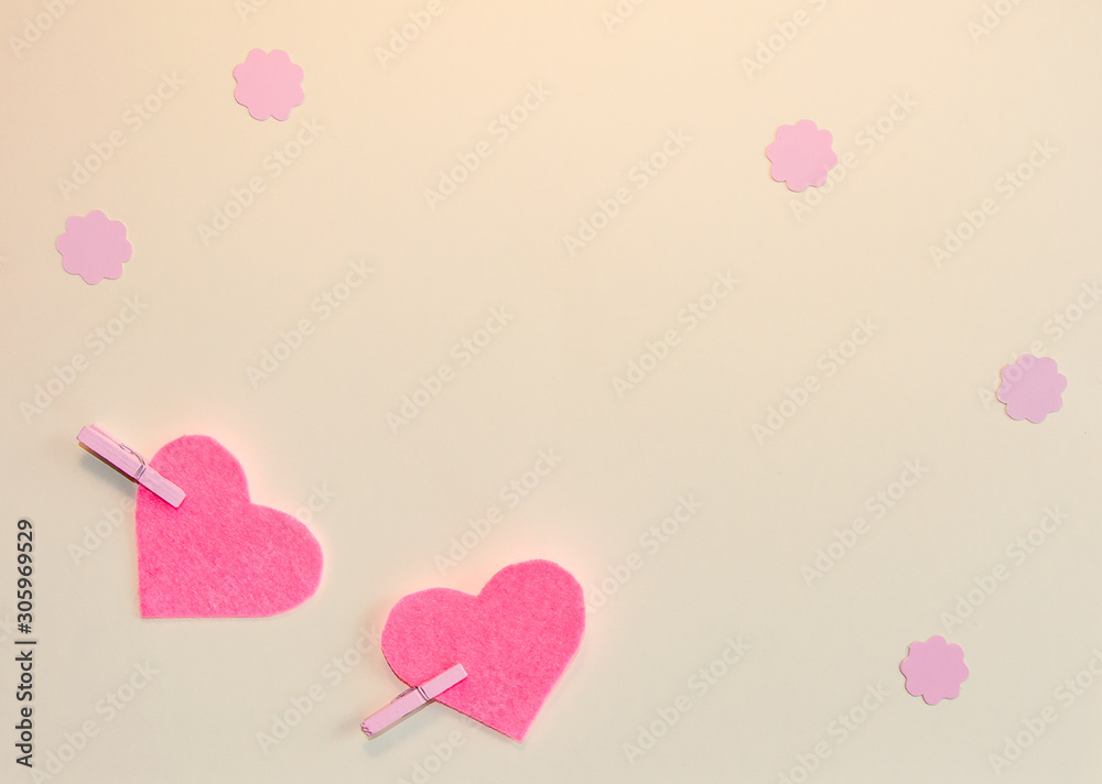 Pink felt hearts and flowers on a beige background. Happy Valentine. Flat lay.