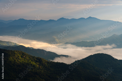 Sun rising over mountains with fog and the light shines beautifully