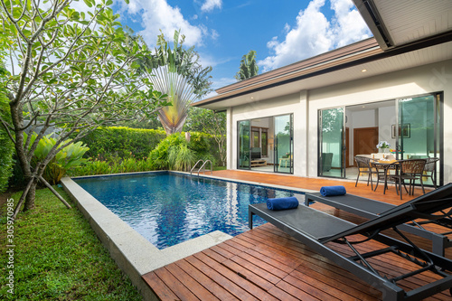 swimming pool and decking in garden of luxury home