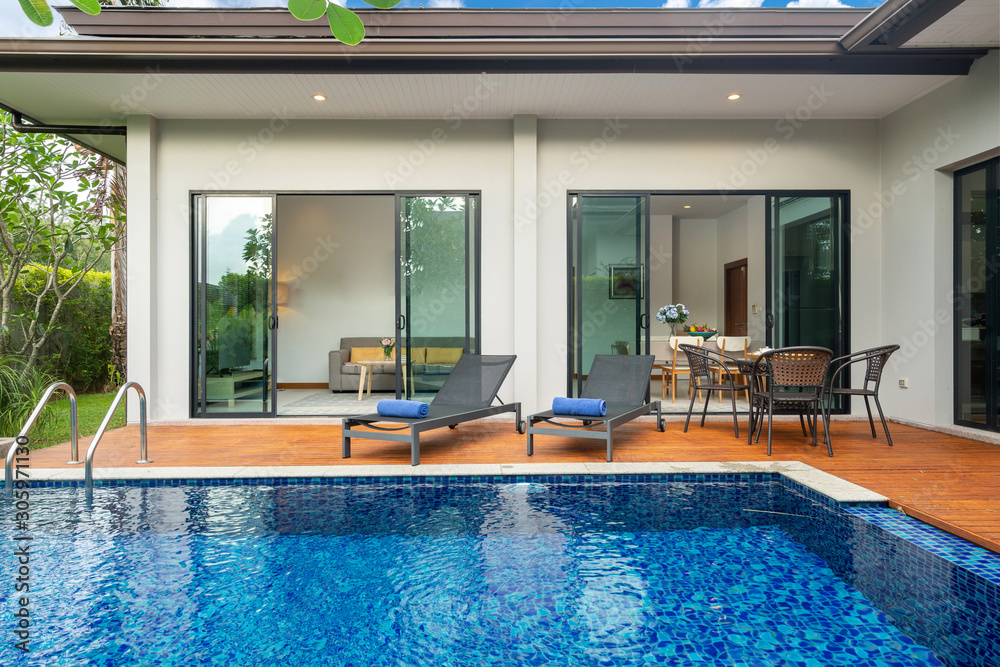 swimming pool and decking in garden of luxury home