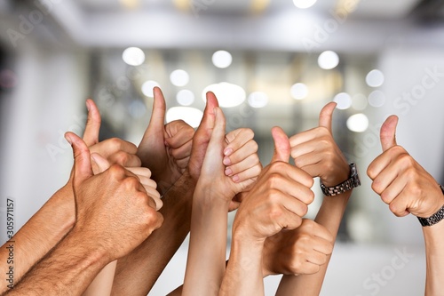 Group of people hands showing thumbs up signs on background