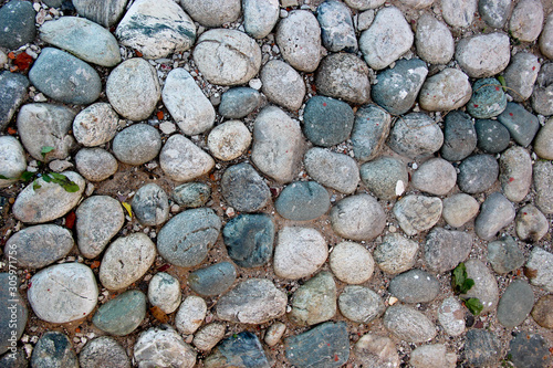 Obraz na plátně An old pebblestone road cobbled with natural stones