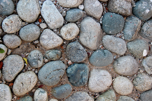 Φωτογραφία Closeup of an old pebblestone road cobbled with natural stones