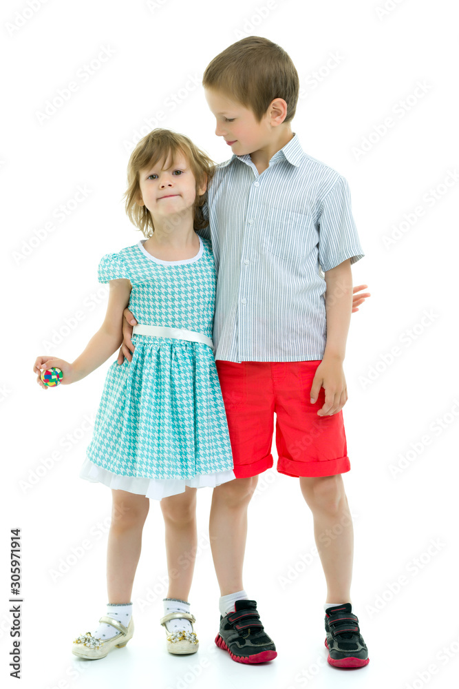 Brother and sister, boy and girl posing in the studio. Friendshi Brother and sister, boy and girl posing in the studio. Friendshi