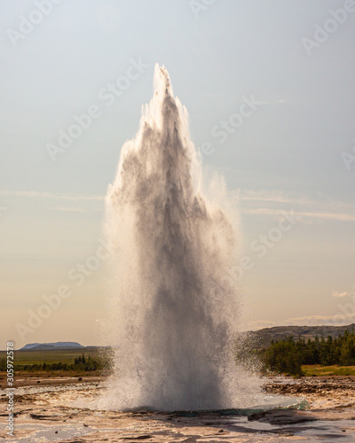 Strokkur big geyser eruption in summer Iceland lanscape, Big geyser in action outbreak, explosion