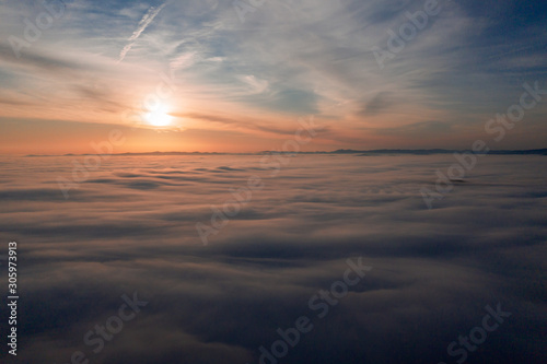 Great view of the foggy sunrise sky in the austrian alps
