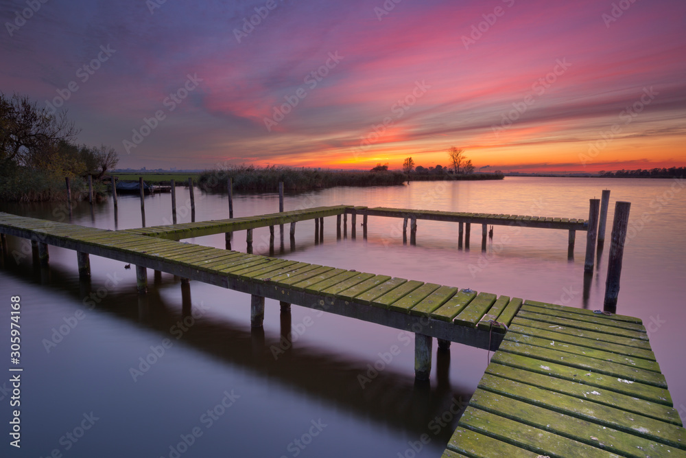 Old jetty on a lake at sunset Old jetty on a lake at sunset