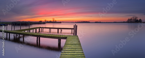 Old jetty on a lake at sunset