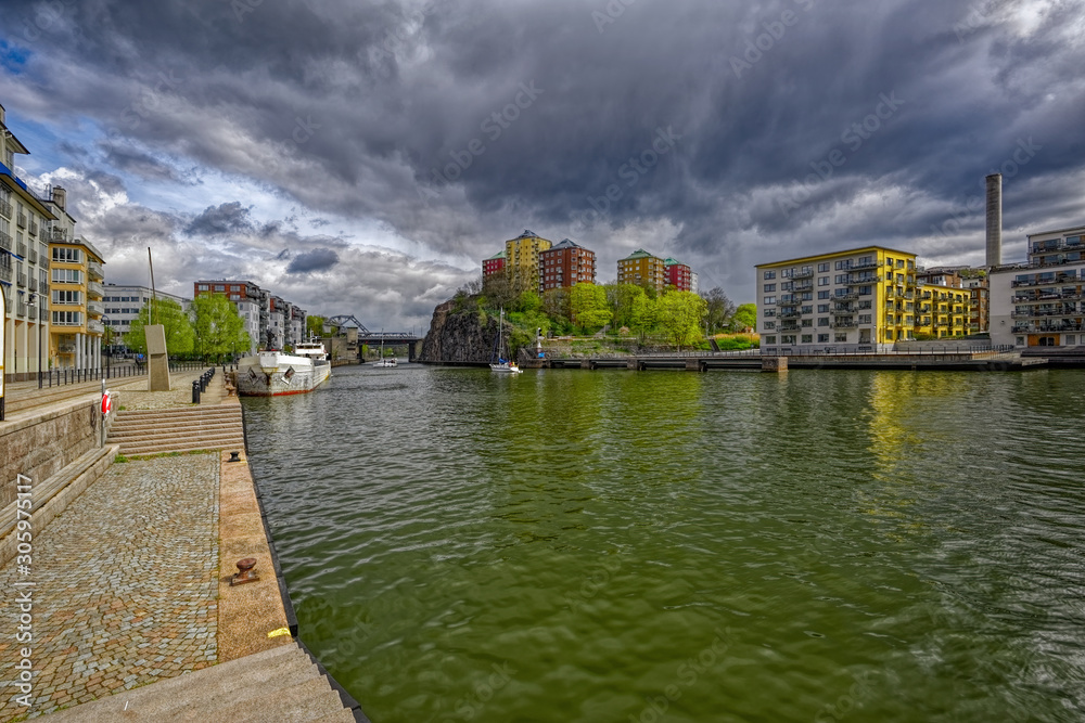 Naklejka premium Old and new waterfront apartment buildings on shore of Hammarby canal. Stockholm, Sweden.