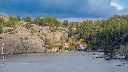 Quiet cove with picturesque summer houses in Stockholm Archipelago in Baltic sea at spring sunny evening.