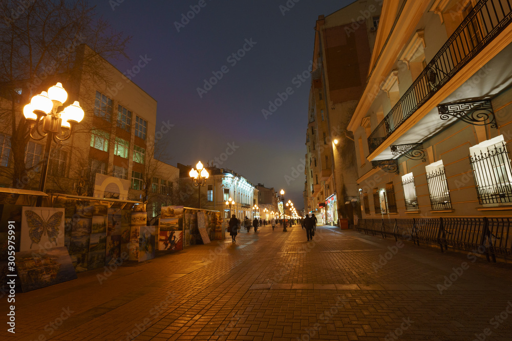 Night cityscape in autumn night. Photography of people walking 