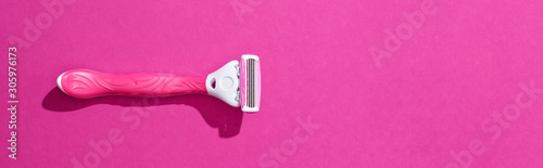 top view of female razor on pink background, panoramic shot