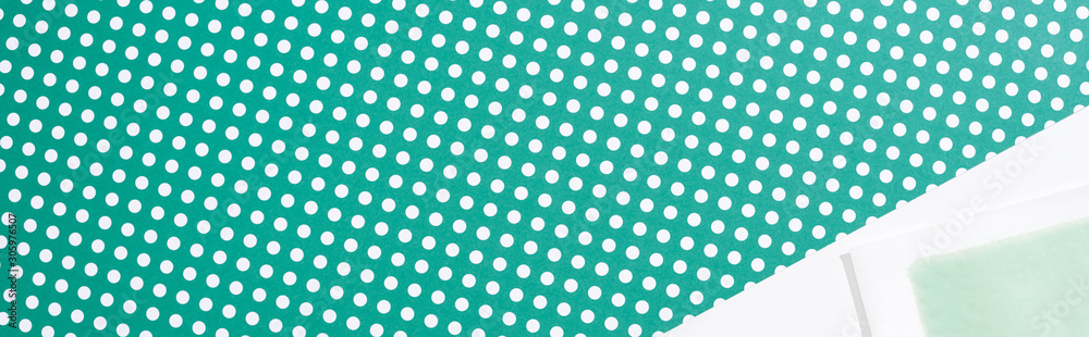 top view of depilation wax stripe on green and white dotted background, panoramic shot