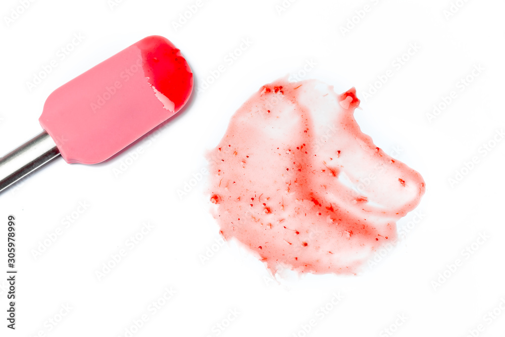 A stain of strawberry jam or fold. On a white isolated background. Abstraction. The culinary spatula