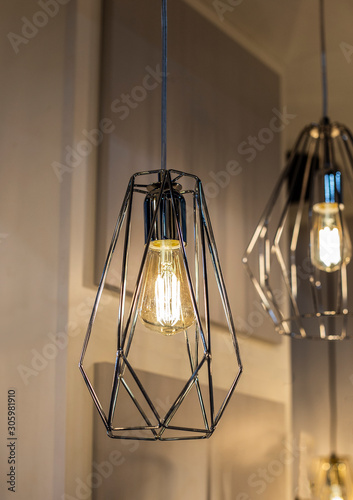 Trendy silver geometric pendant lamp with a bulb close up photo with selective focus photo