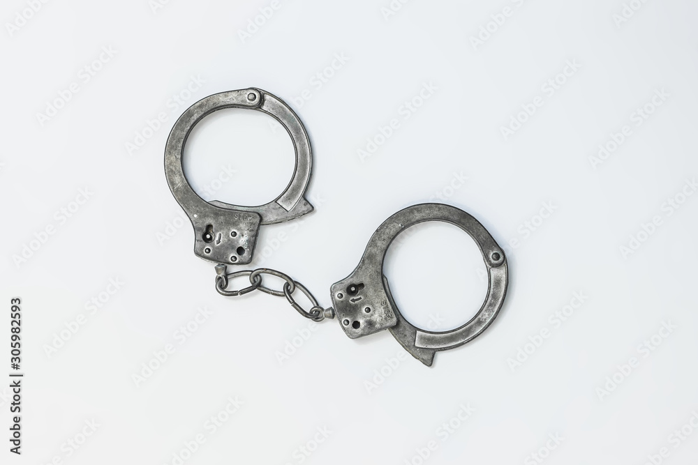Closed handcuffs on white background isolate Closed handcuffs on white background isolate