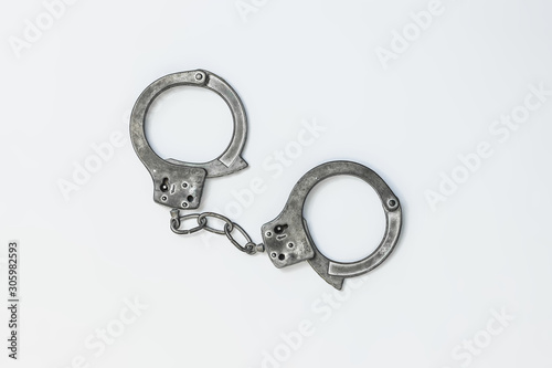 Closed handcuffs on white background isolate