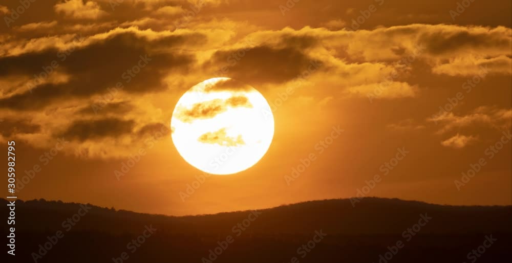 Sunrise timelapse in mountain. Big sun close-uo and clouds motion. Nature composition.