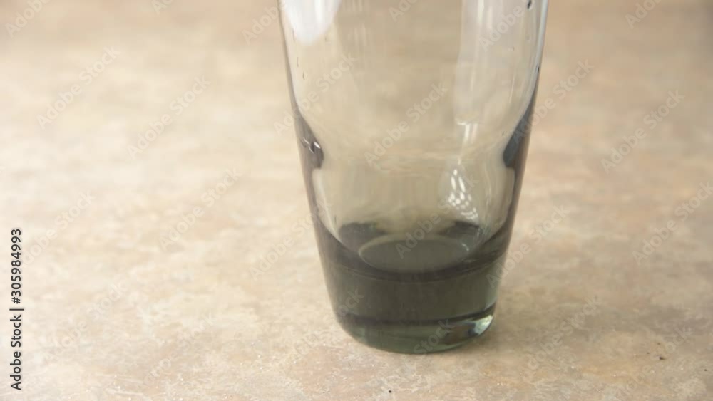 Filling Glass Cup with Orange Juice on Countertop 60fps Filling Glass Cup with Orange Juice on Countertop 60fps