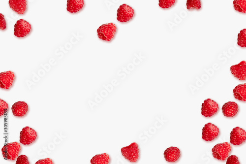 Juicy ripe red raspberry berries frame on a pink background with place for text