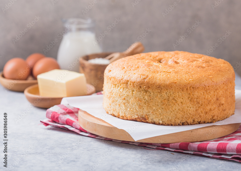 Homemade Soft and lite delicious sponge cake with ingredients: eggs flour milk on stone concrete table. Bakery background concept. Homemade Soft and lite delicious sponge cake with ingredients: eggs flour milk on stone concrete table. Bakery background concept.