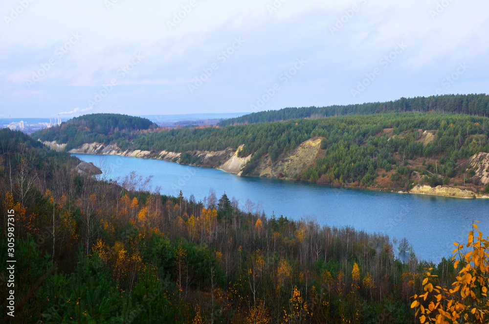 Artificial lake was is formed after the extraction of chalk in an industrial quarry at Krasnoselsky village in the Belarus. Water in open pit between the mountains. Belarusian Maldives Artificial lake was is formed after the extraction of chalk in an industrial quarry at Krasnoselsky village in the Belarus. Water in open pit between the mountains. Belarusian Maldives