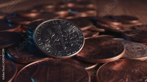 A shiny American dime stands out among pennies photo