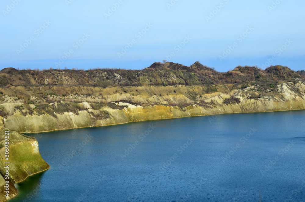 Artificial lake was is formed after the extraction of chalk in an industrial quarry at Krasnoselsky village in the Belarus. Water in open pit between the mountains. Belarusian Maldives Artificial lake was is formed after the extraction of chalk in an industrial quarry at Krasnoselsky village in the Belarus. Water in open pit between the mountains. Belarusian Maldives
